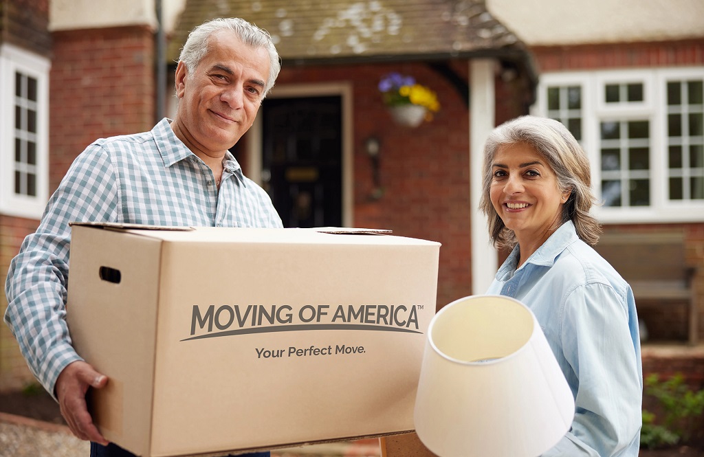 Senior Couple Holding Box and Lamp