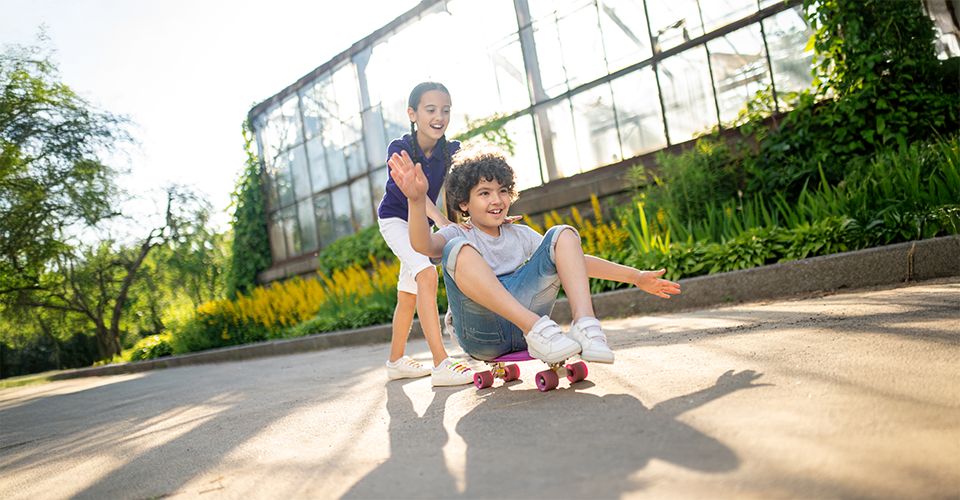 Children playing safely in a fenced backyard during the day
