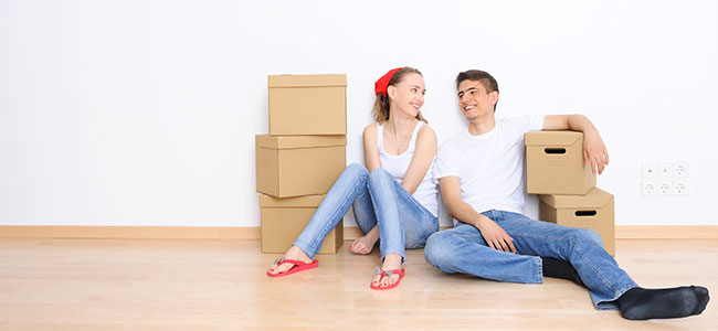 Couple sitting with moving boxes